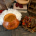 This shows Wallace the pumpkin with his hat off and sitting next to him. It shows his wispy hair that is attached to the rim of the gourd.